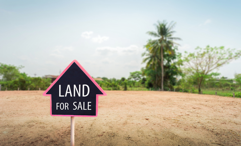 Empty land with sale sign