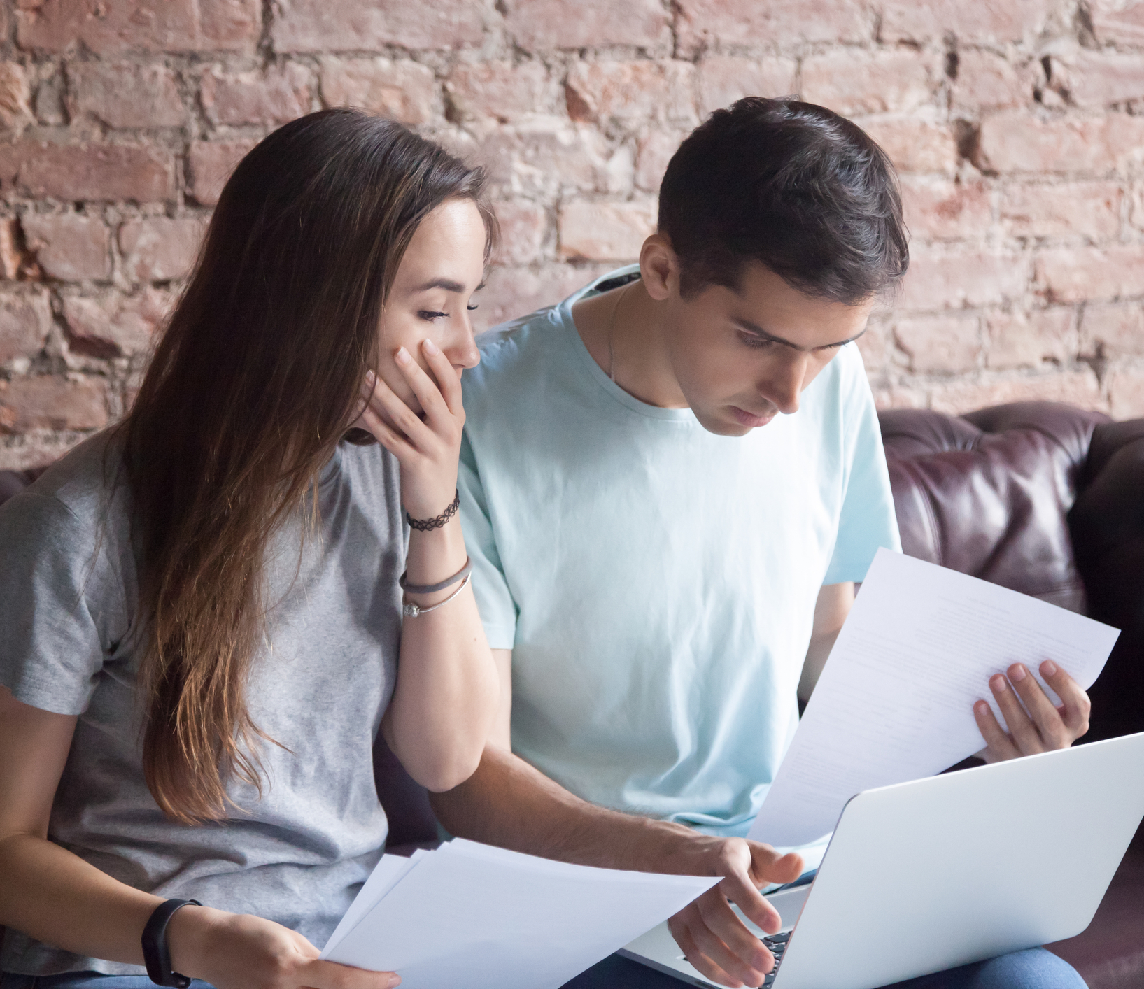 Couple studying the design process together with documents.